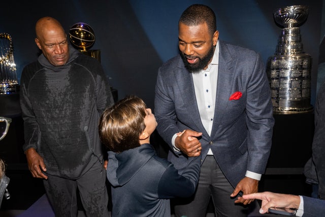 Ron Harper and Chris Canty greet a guest at PaleyWKND outside the Paley Museum on October 01, 2022 in New York City. 