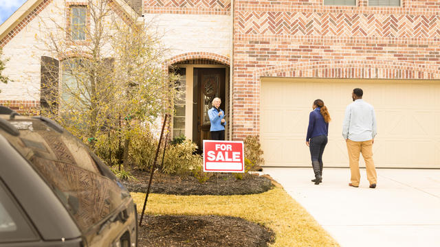 Real Estate: African descent couple meets with Real Estate Agent. Buying home. 