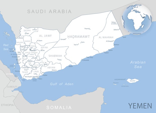 Blue-gray detailed map of Yemen administrative divisions and location on the globe.