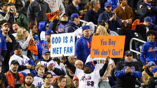 New York Mets fans hold signs against the San Diego Padres in game two of the Wild Card Series at Citi Field on October 08, 2022 in New York City. 