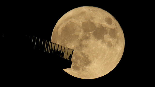 The Full Hunter's Moon Rises Behind EdgeNYC in New York City 