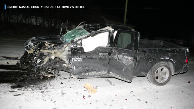 A pick-up truck with severe front-end damage. 