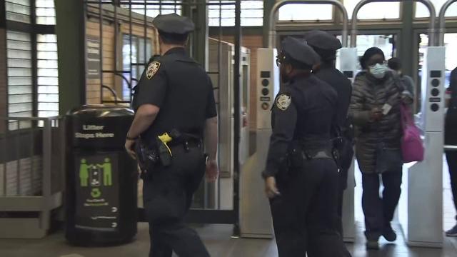 NYPD officers walk through a subway station in New York City. 