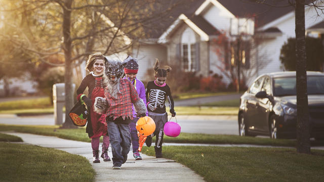 Little boy and Little girl trick or treating 