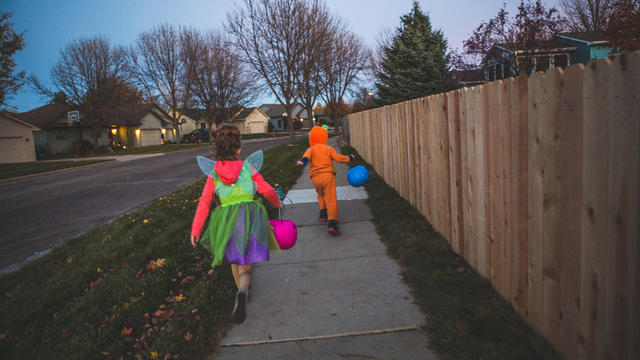 Little boy and Little girl trick or treating 