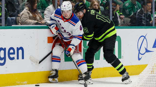 New York Rangers defenseman Zac Jones (6) and Dallas Stars center Radek Faksa (12) battle for the puck along the boards during the game between the Dallas Stars and the New York Rangers on October 29, 2022 at American Airlines Center in Dallas, Texas. 