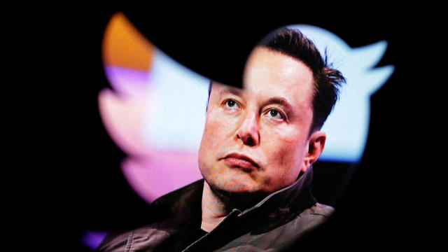 Elon Musk's photo is seen through a Twitter logo in this illustration made October 28, 2022. 