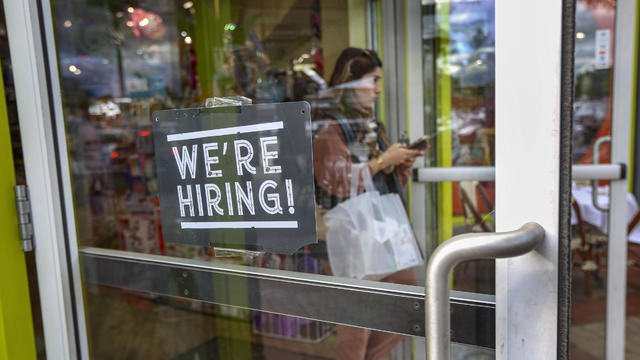A "We're hiring" sign in the door of a Long Island toy store 