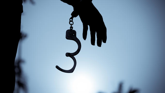 Cropped Hand Of Men Removing Handcuffs 