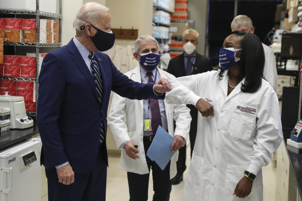 President Biden wears a protective mask while greeting Kizzmekia Corbett, an immunologist with the vaccine research center at the National Institutes of Health, during a tour in Bethesda, Maryland, on Feb. 11, 2021. 