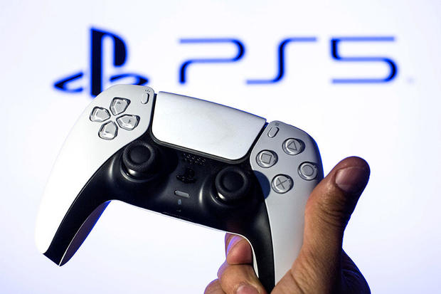 In this photo illustration, a PlayStation 5 controller seen 
