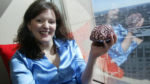 (03/01/06 - Boston, MA) Lisa Harvey, a cognitive scientist recently hired by Arnold Worldwide, poses with a model brain in her new 20th floor office. (030106arnoldjw - Staff photo by John Wilcox - Saved in Photo Thu.) 