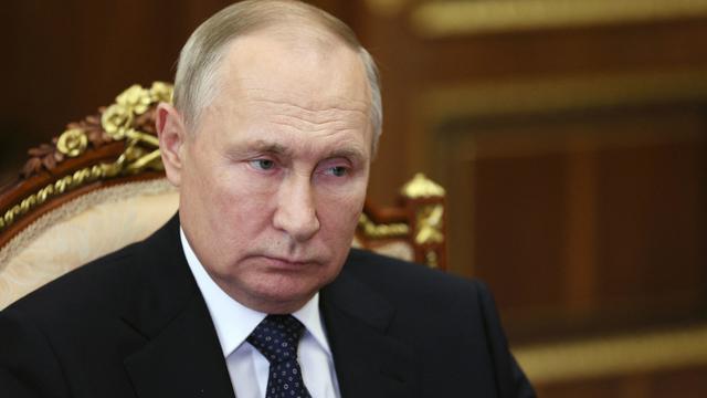 Headshot of Vladimir Putin looking dour 
