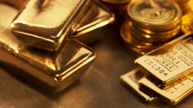 Gold ingots and coins close up 