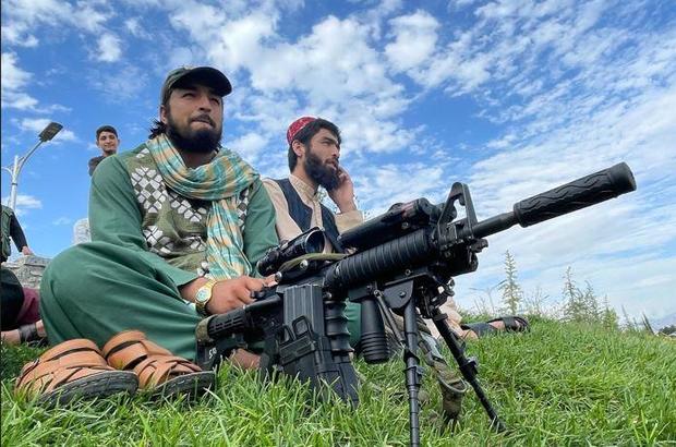 Taliban militants sit in a Kabul park in August 2022