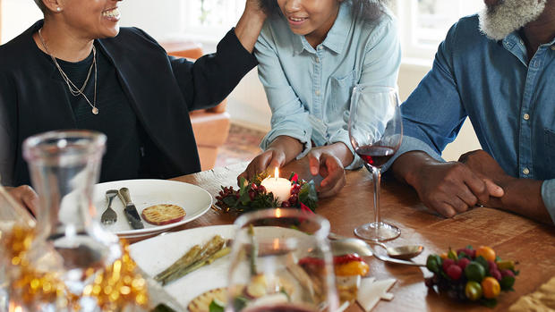 Woman serving appetizer to friends and family 