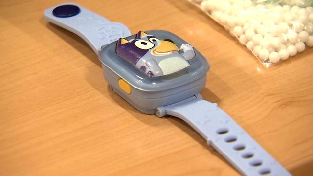 A "Bluey" watch sits on a table. 
