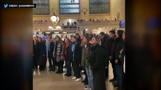 A group of children stand in Grand Central Station. 