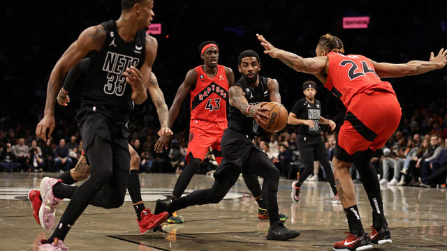 Kyrie Irving #11 of the Brooklyn Nets goes to the basket past Khem Birch #24 of the Toronto Raptors during the first half at Barclays Center on December 2, 2022 in New York City. 