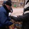 Ukrainians feed each other and repair power lines as Russian attacks continue