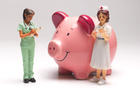 Piggy bank flanked by nurse and doctor figurines 
