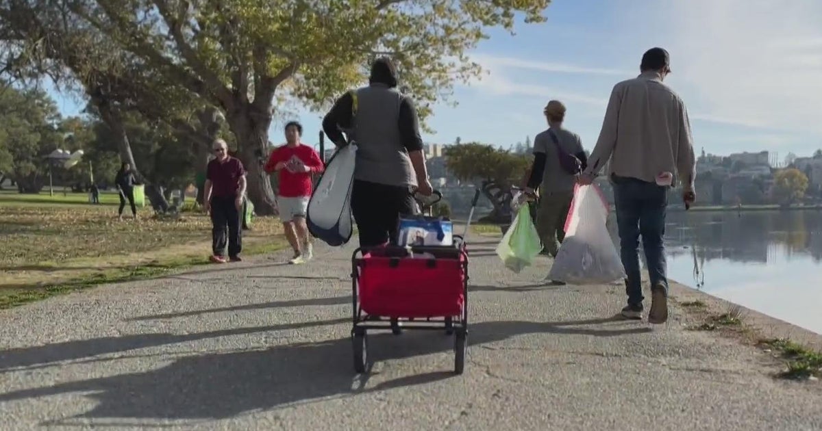 Group of volunteers bonds over cleaning up trash around Oakland's Lake