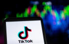 In this photo illustration a TikTok logo seen displayed on a 