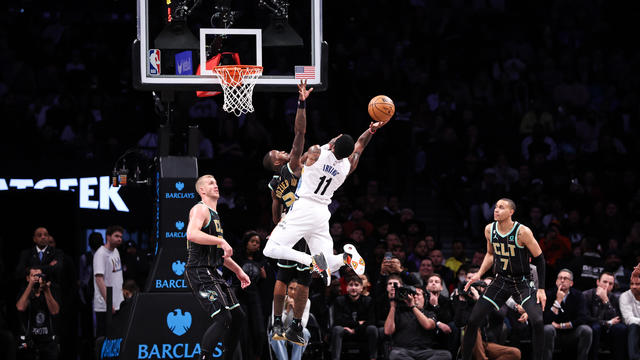 Kyrie Irving #11 of the Brooklyn Nets shoots the ball defended by Terry Rozier #3 of the Charlotte Hornets during the fourth quarter of the game at Barclays Center on December 07, 2022 in the Brooklyn borough of New York City. 