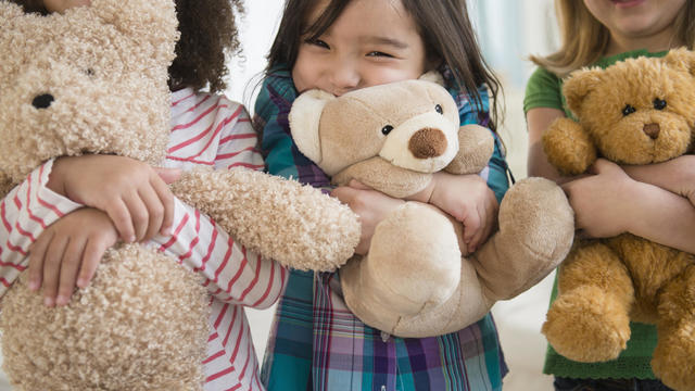 Girls hugging teddy bears 