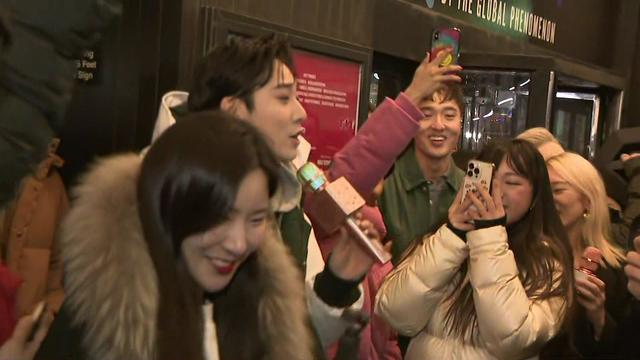 "KPOP" cast members sing outside the entrance to the Circle in the Square Theatre. 