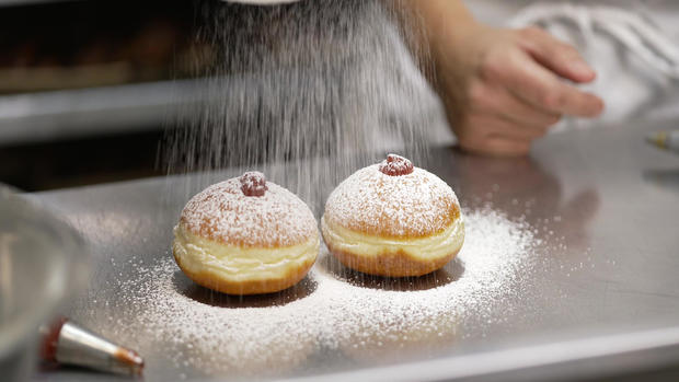 hanukkah-doughnuts-spraying-with-sugar.jpg 