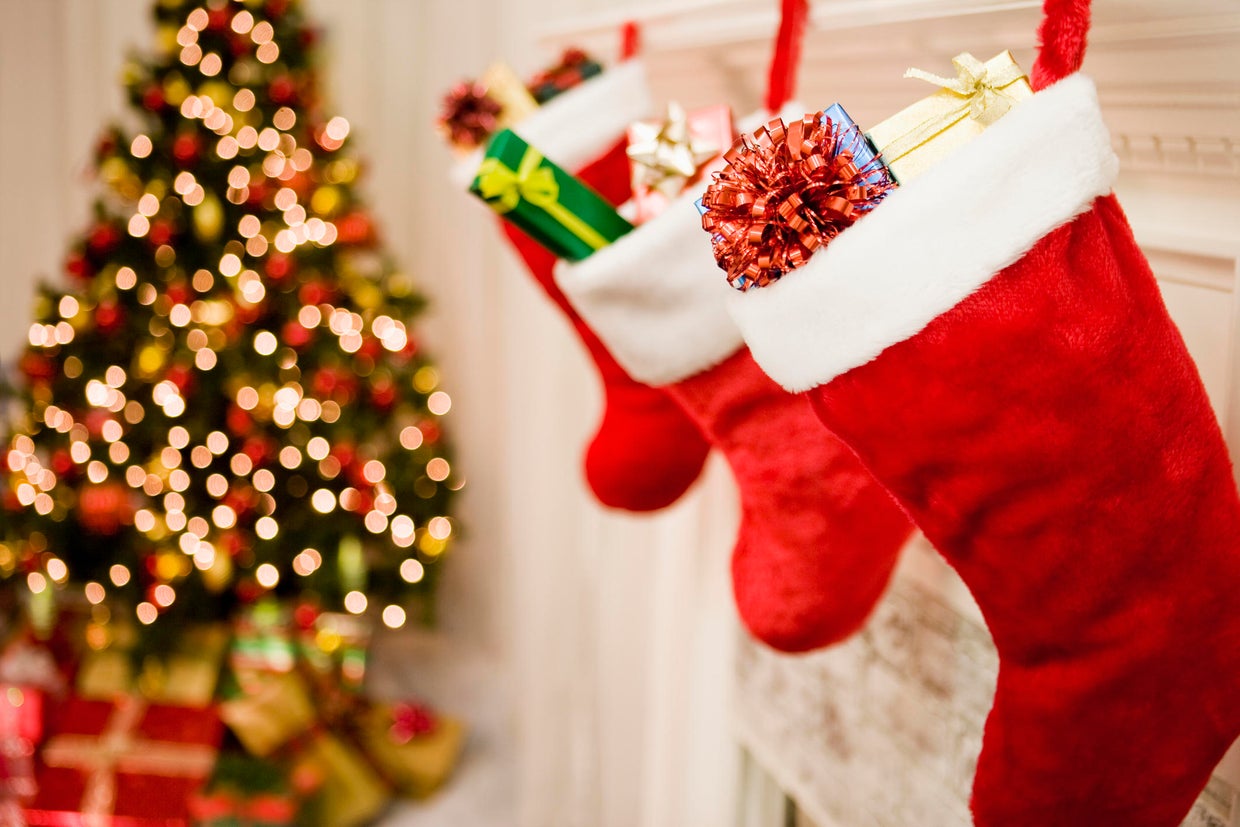 Christmas stockings hanging, Christmas tree in background, close-up 