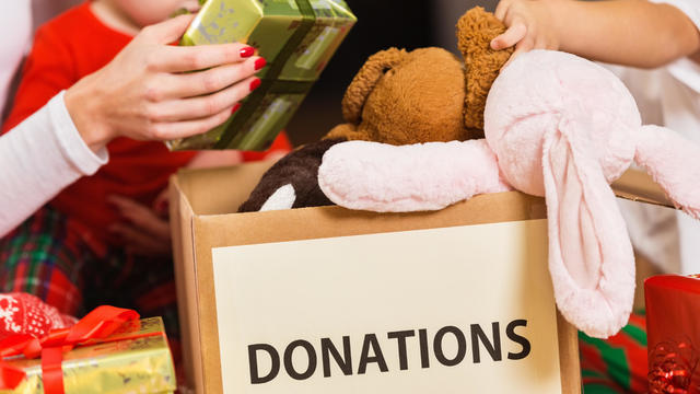 Family donating gifts and toys to charity for Christmas holiday 