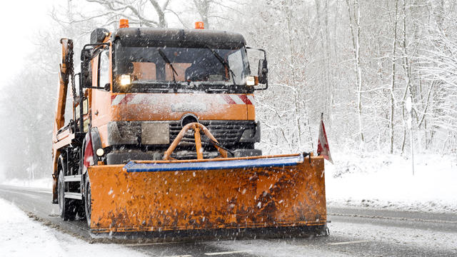 Snow plow truck - winter road conditions, heavy snowfall 