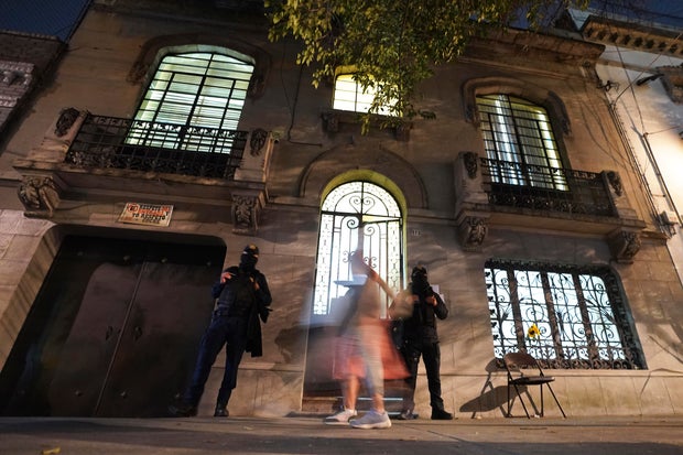 Police guard a house where three people were killed in Mexico City, Dec. 22, 2022. 