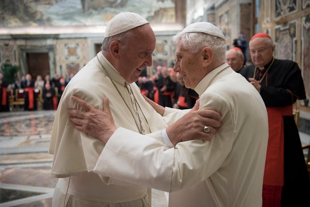 FILE PHOTO: Former pope Benedict is greeted by Pope Francis during a ceremony to mark his 65th anniversary of ordination to the priesthood at the Vatican 