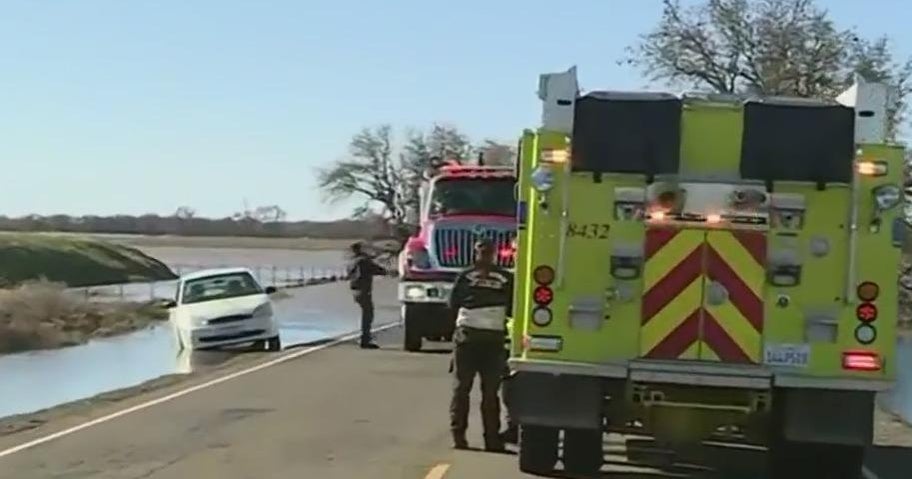 Emergency vehicles respond to submerged vehicle along Dillard Road