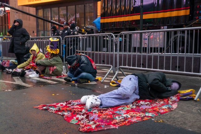 Revelers wait in the rain at Times Square for the midnight ball drop for the New Year's Eve celebration on December 31, 2022 in New York City. 