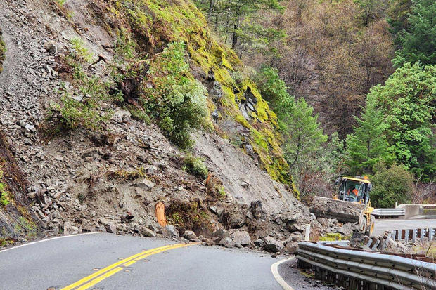 This photo provided by Micah Crockett of the California Department of Transportation shows heavy machinery removing a rock slide on State Route 299 in Trinity County, Calif., Dec. 31, 2022. 