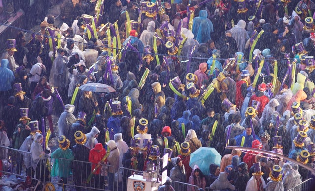 Revelers stand in the rain as they celebrate New Year's Eve in Times Square on December 31, 2022, in New York City. 