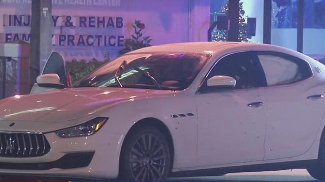Woman rushed to hospital after car shot multiple times 