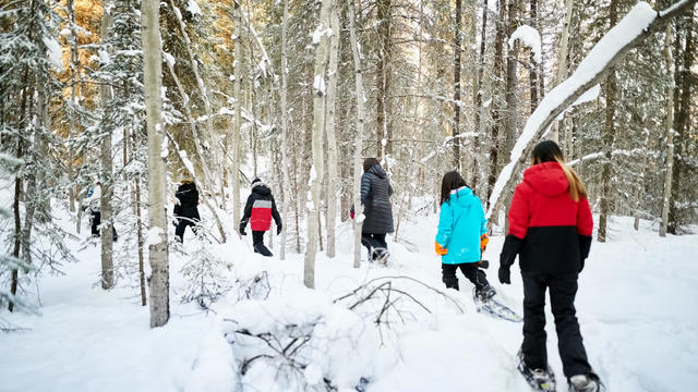 Group of students learning to snowshoe in a school 