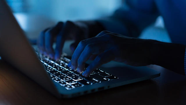 close up programmer man hand typing on keyboard laptop for register data system or access password at dark operation room , cyber security concept 