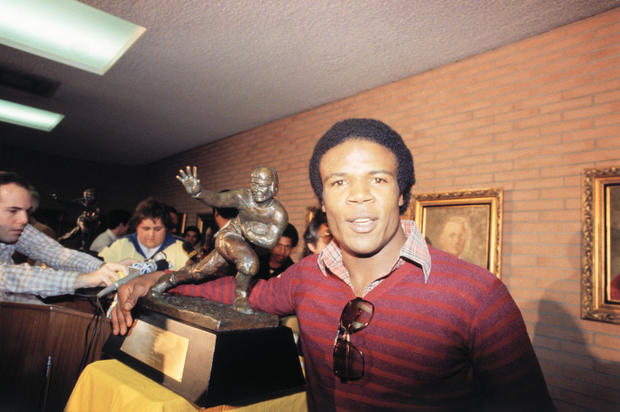 Charles White Posing with Heisman Trophy 