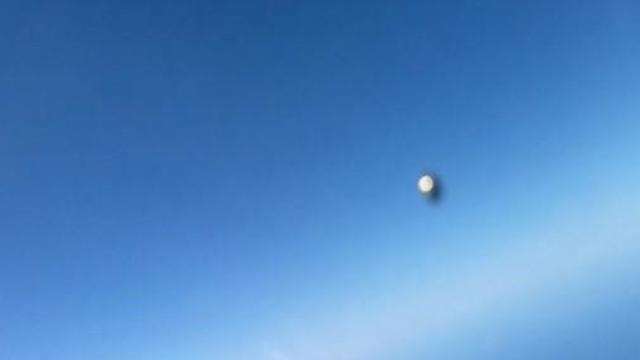 A screen capture of a video showing an unknown object flying past by a U.S. Navy pilot. 