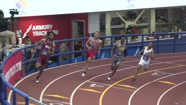 Four athletes round a curve in the track at the Nike Track and Field Center at the Armory in Washington Heights. 