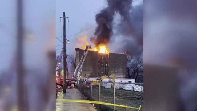 Flames and smoke can be seen pouring from the roof of an apartment building in Yonkers. 