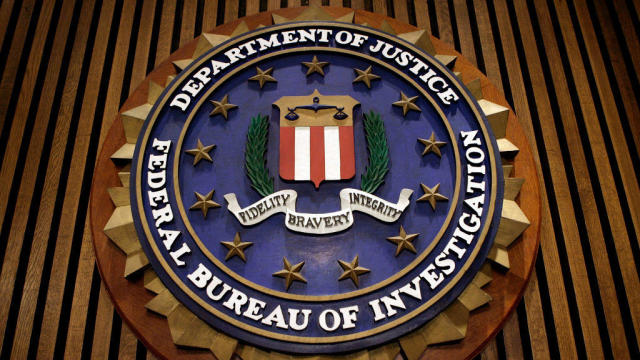 The seal of the FBI hangs in the Flag Room at the bureau's headquarters on March 9, 2007, in Washington, D.C. 