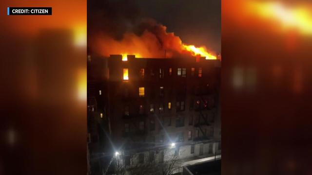 Massive flames can be seen on the top floor of a Bronx apartment building. 
