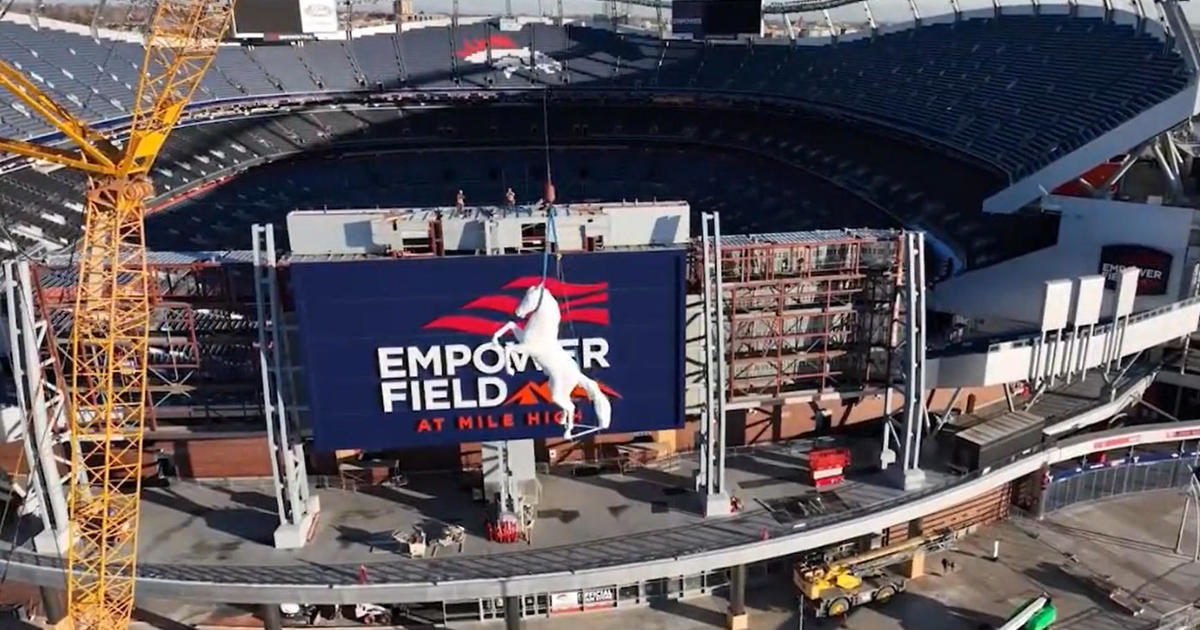 Last large section of the Mile High stadium during demolition : r